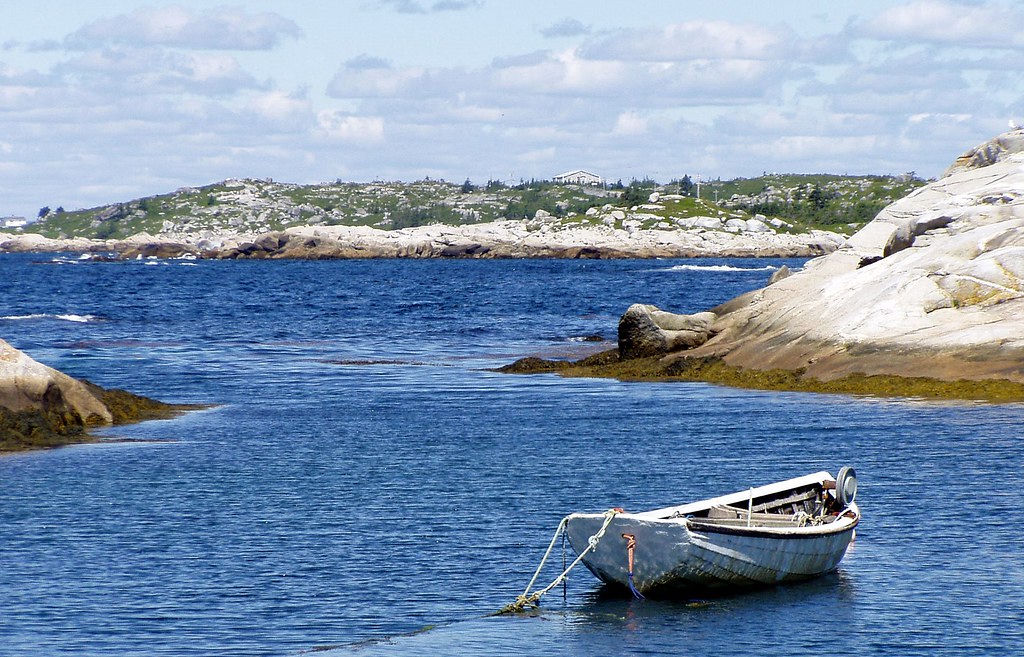 A small boat in a small cove.