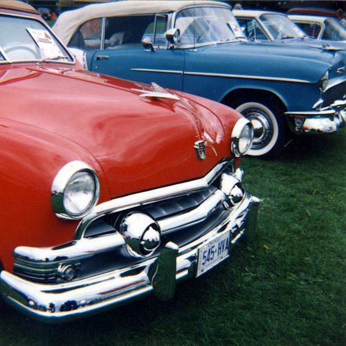 Two old cars in red and blue.