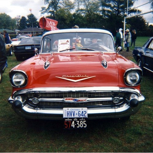 An old red car, seen from the front.