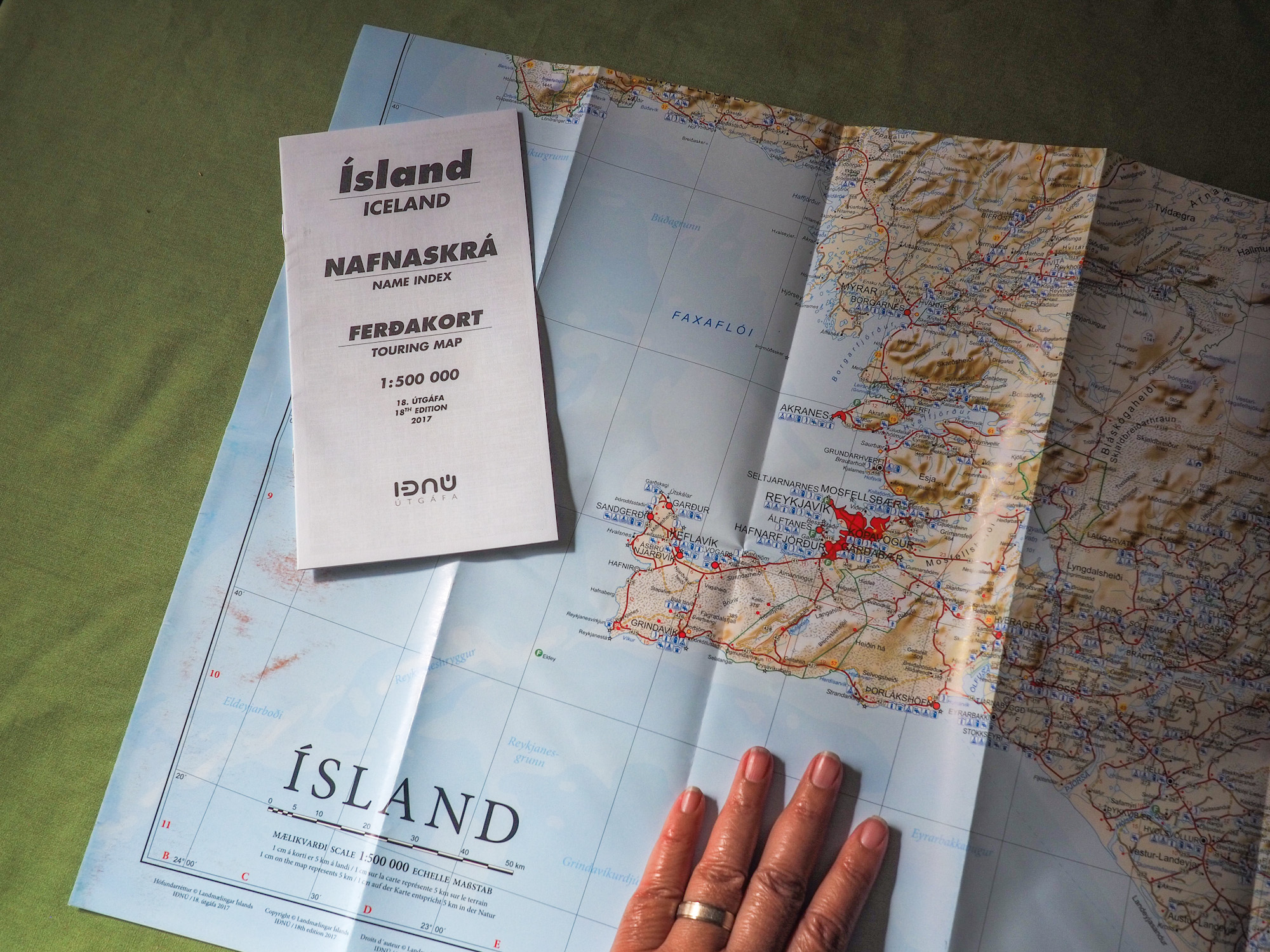 An unfolded paper road map of Iceland.